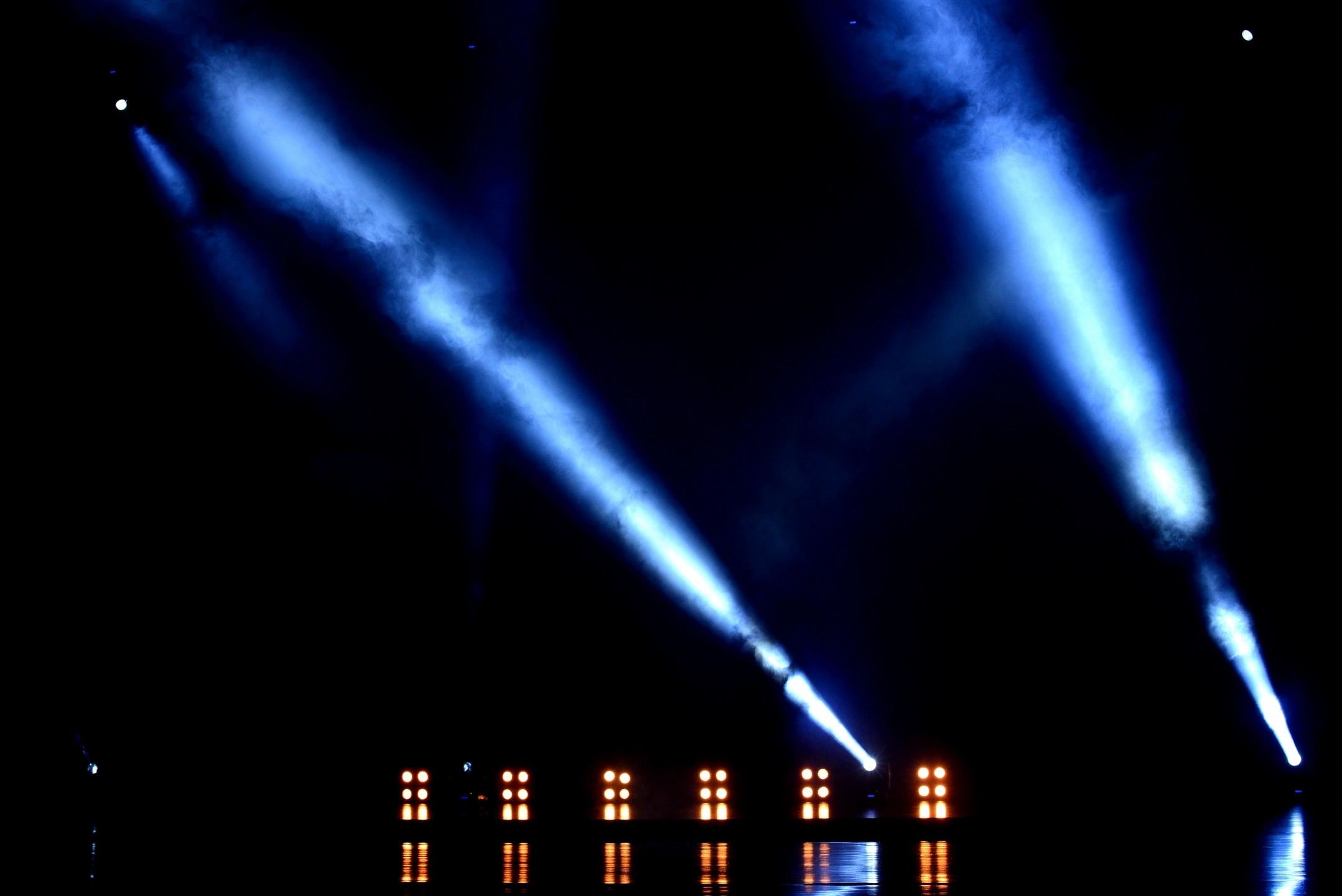 Live concert stage with dramatic blue lighting at a CJnCO-managed event
